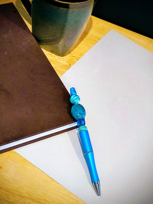 Be the talk of the office with these wonderful colorful fun pens. Each pen comes with an extra ink cartridge. This is a Cracked Blue Stone and Blue Beaded decor on a Baby Blue Pen. 
Dimensions 5.75" x .5" x .5". Weight .41 Oz.