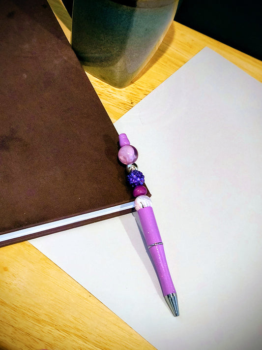 Be The Talk Of The Office With These Colorful Decorative Ballpoint Pens. Each Pen comes with an extra ink cartridge. This is a Purple Swirl Beaded Decor on a Purple Ballpoint Pen.
Dimensions 5.75" x .5" x .5". Weight 0.42 Oz.