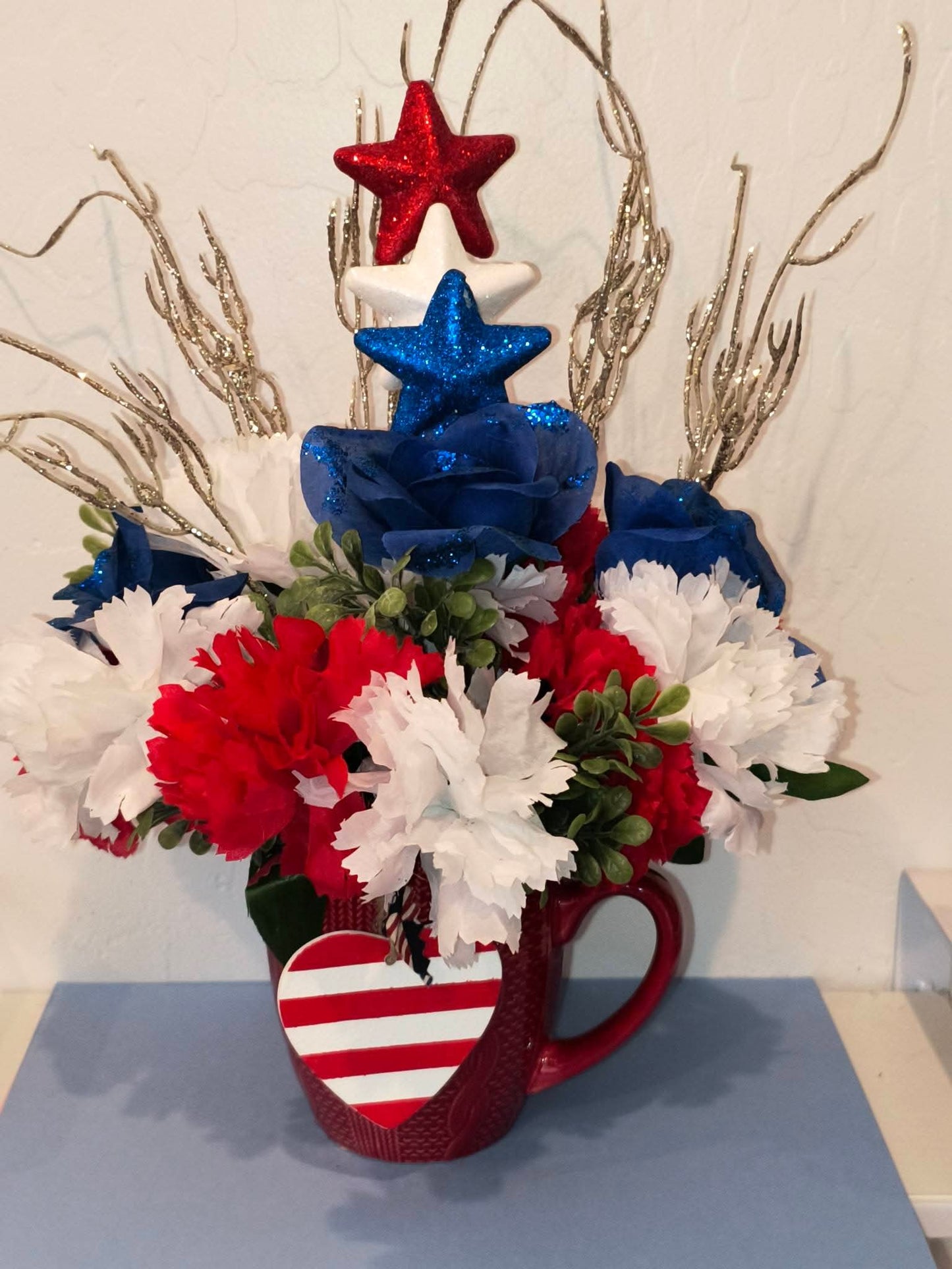 Red White and Blue Floral Arrangement in Tea Cup