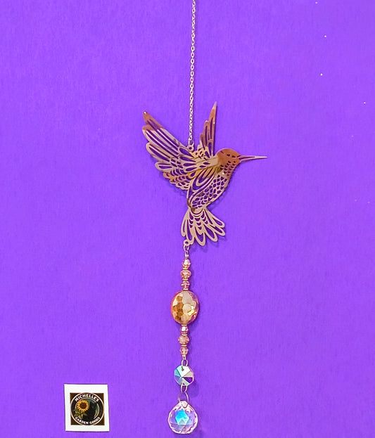 Single Strand Suncatcher With a Hummingbird in Tan and Crystal Beads.  This is a Sparkling Piece to Hang in your Garden or Home.
Dimensions 9" x 4" x 1 mm. Weight 1.01 Oz.