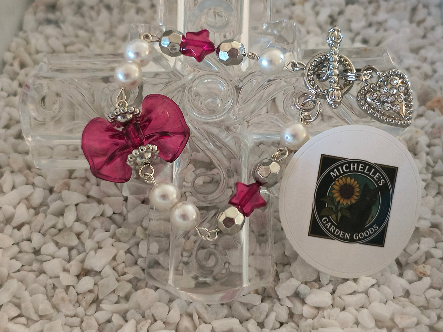 Coquette Beaded Bowtie Pearl Bracelet With Rhinestone Heart Clasp in Silver 
Dimensions H 7" x L 1.125" x W 0.375". Weight 0.40 Oz.