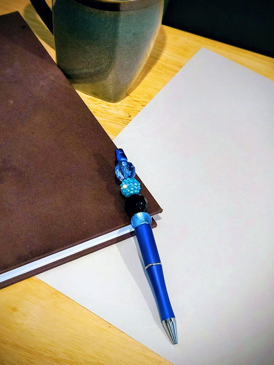 Be the talk of the office with these wonderful colorful fun pens. Each pen comes with an extra ink cartridge. This is a Cracked Blue Stone and Blue Beaded decor on a Baby Blue Pen. 
Dimensions 5.75" x .5" x .5". Weight .41 Oz.