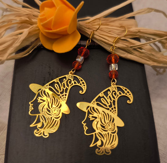 Orange Glass Beaded Witch Earrings /Gold in color
Dimensions H 3" x L 1.25" x L 0.25". Weight 0.15 Oz.
