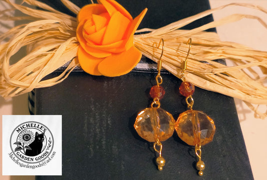 Burnt Orange Glass Beaded Earrings In Gold
Dimensions H 2.5" x L 0.625" x W 0.25". Weight 0.05 Oz.