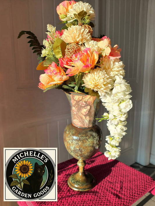This Decoupage Fairy Arrangement was created on a Brass Vase that had a Beautiful Patina.The Decoupage Fairy added and also sealed. A Beautiful Asymmetrical Floral Design with Chrysanthemums, Peonies and Hydrangea Vines.
The A-frame Floral Design just adds to it's Vintage look. 
30 inches tall 