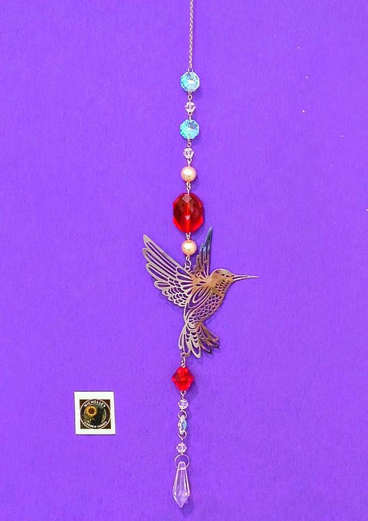 Single Strand Suncatcher With a Hummingbird in Red and Crystal Beads. This is a Sparkling Piece to Hang in the Garden or Home for Decor.
Dimensions 13" x 4" x 1 mm. Weight .95 Oz. 