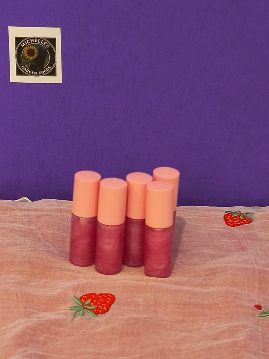 Strawberry Banana Pink Lip Gloss With Glitter
Ingredients: Lip Gloss Base With Glitter, Elderberries infused with Jojoba Oil, Pink Mica Powder and Strawberry &amp; Banana "Safe for Lips" Flavor.


Great For Moisturizing, Soothing and Nourishing.

Dimensions H 2" x L 0.5" x W 0.5". Weight 0.13 Oz.