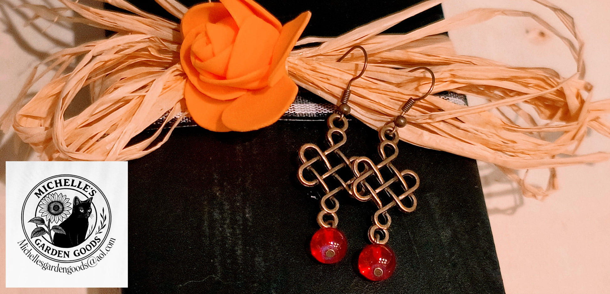 Trinity Knot Cross Design Earrings With Red Glass Beads&nbsp;

Hypoallergenic material: Alloy, Brass, Iron, Glass, cadmium Free & Nickel Free  & Lead Free.

Dimensions H 2" x L 0.75" x W 0.375". Weight 0.18 Oz.