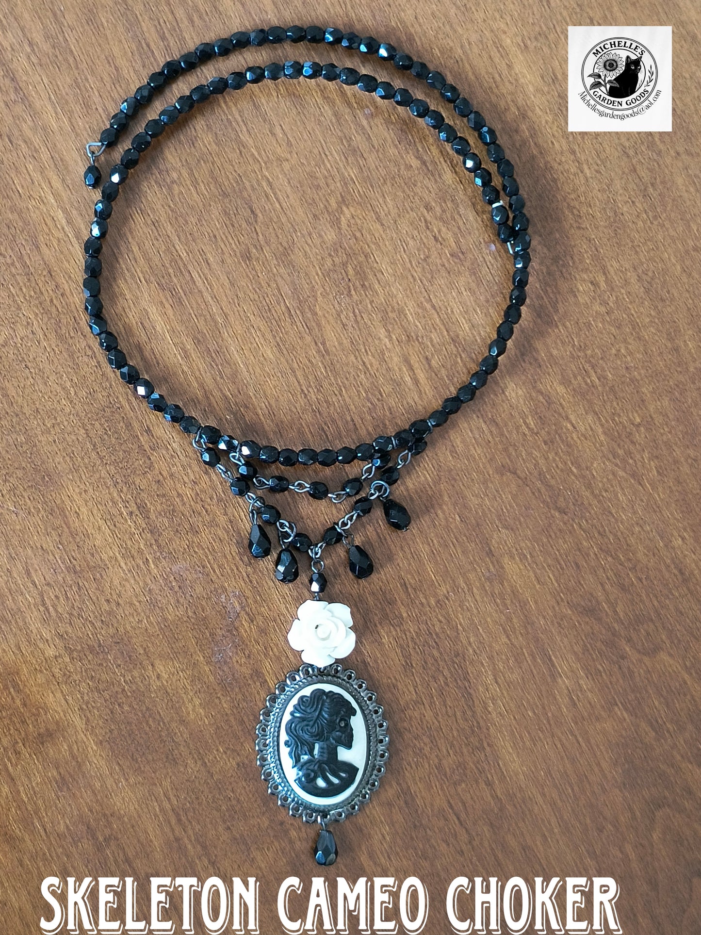 This Handmade Dangling Skeleton Cameo Choker With Crystal Black Beads can fit all neck sizes as it stretches out.&nbsp;

Resin Charm

Dimensions H 8.5" x L 1.125" x W .25". Weight 0.52 Oz.